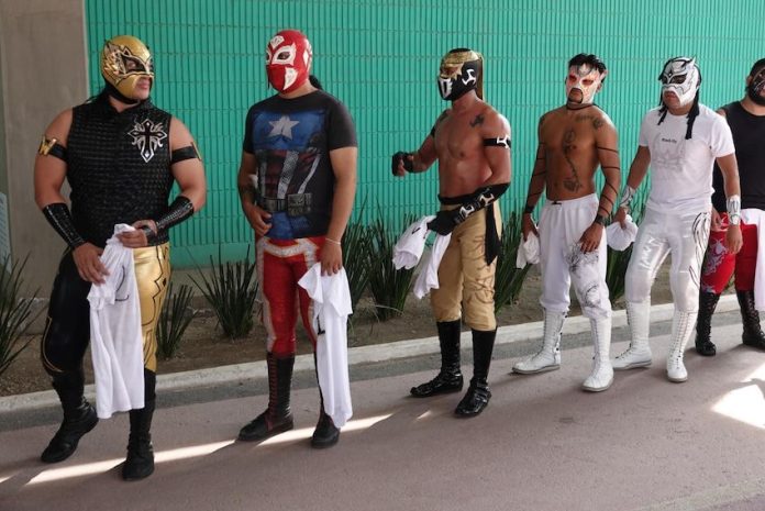 A group of traditional luchadores, ready to compete in Lucha por el Barrio tournament.