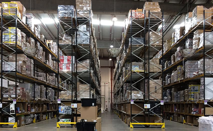 An Amazon e-commerce warehouse filled with shelves and shelves of cardboard boxes