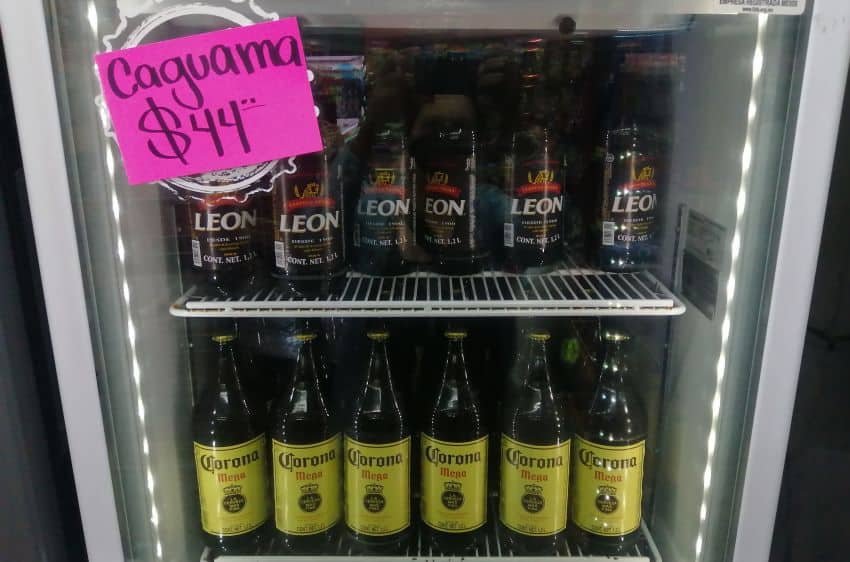 Convenience store refrigerator in Mexico filled with bottles of Corona and Leon brand beers.