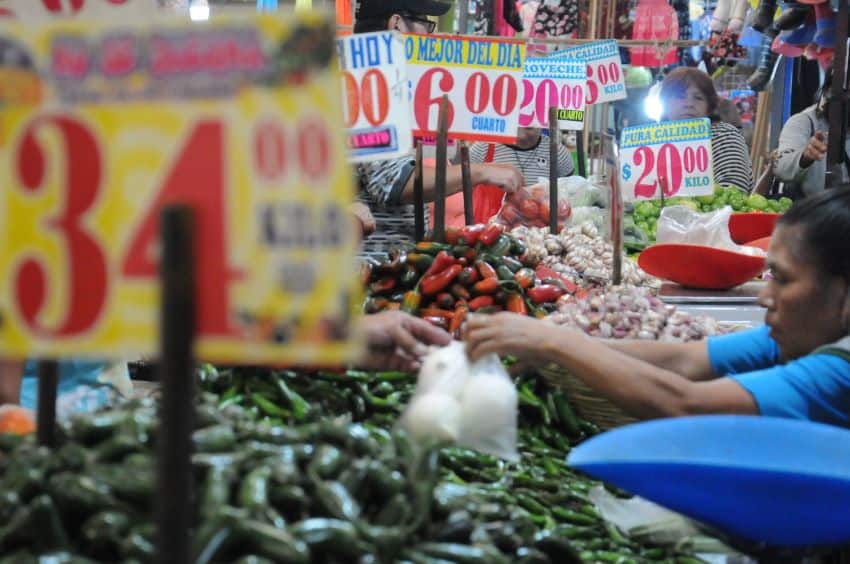 Price labels above produce in a Mexican market