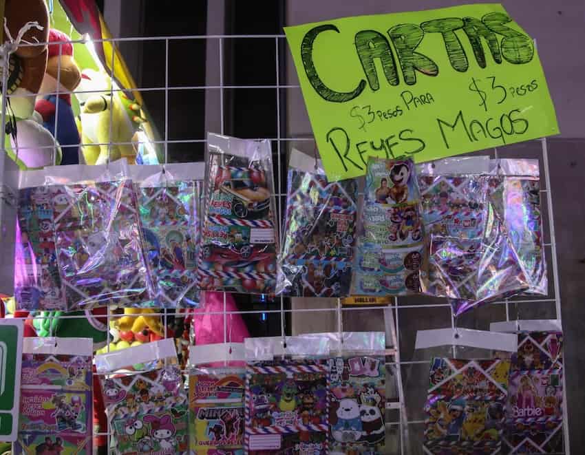 A sign at a market stand reads "Cartas Reyes Magos" and displays gift prices ahead of King's Day in Mexico