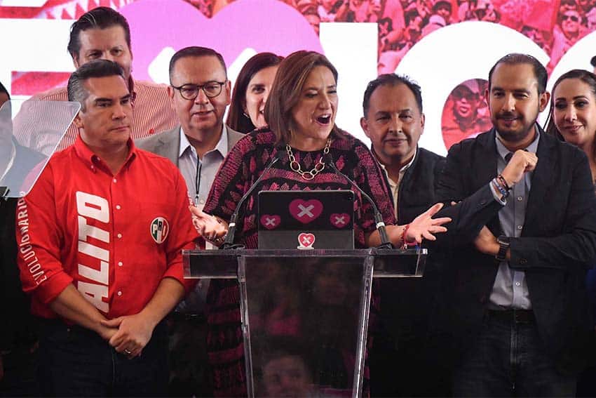 Xochitl Galvez at a podium on election night, June 2, 2024, surrounded by her election team