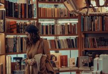 A woman browses books at a bookstore