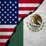 U.S. and Mexican flags with a concrete-like crack running between them.