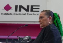 Mexico's elections chief Guadalupe Taddei stands in front of a sign reading "INE: Instituto Nacional Electoral"