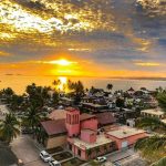 An aerial view of a sunset over the palm-filled seaside town of La Manzanilla, on the Costalegre of Jalisco in Mexico