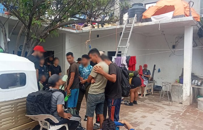 A group of migrants gather in the courtyard of a compound in Oaxaca, shortly after their rescue by government officials