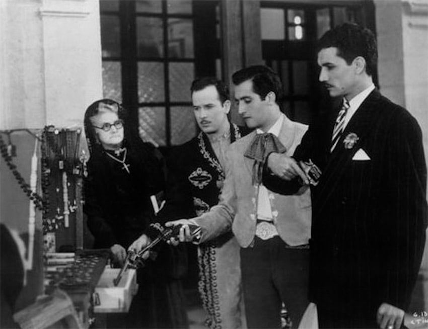 Pedro Infante along with two young men and and old woman in a black and white scene from the 1947 film "Los tres García."