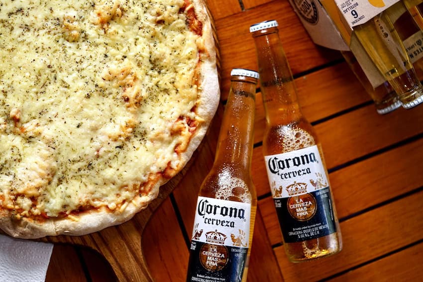 A pair of Coronita beers with a pizza