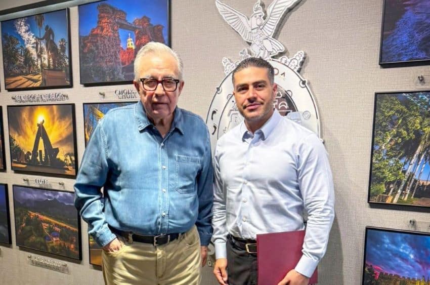 Rocha Moya, and elderly man in a blue dress shirt, poses with Security Minister García Harfuch, a younger black-haired man