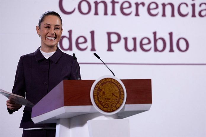 President Claudia Sheinbaum smiles from the podium during her morning press conference, or mañanera