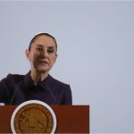 Mexico's President Claudia Sheinbaum at a podium talking to reporters about Mexico's national water plan at a press conference.