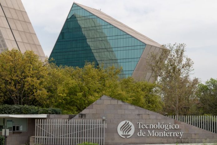 A sign reads Technológico de Monterrey, with glass and metal buildings in the background