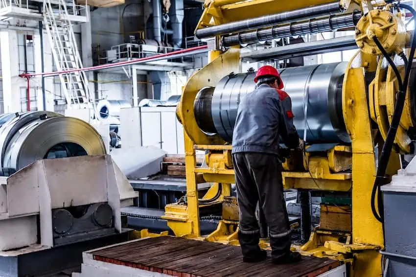 A welder works in a warehouse